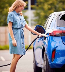 jpeg-optimizer_jpeg-optimizer_woman-attaching-charging-cable-to-environmentally-2024-10-21-05-21-54-utc